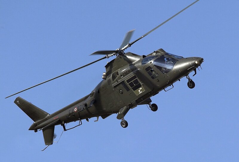 Military Helicopter in Flight — Green, Dynamic, Afternoon, Photograph, Sky, Wheels