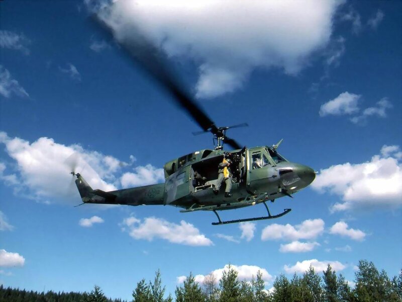 Military Helicopter in Flight — Green, Dynamic, Afternoon, Photograph, Soldier