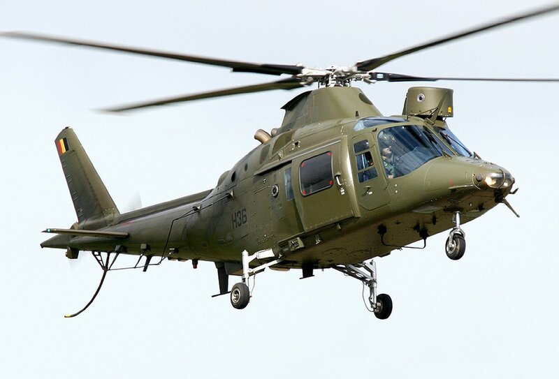 Military Helicopter in Flight — Green, Neutral, Afternoon, Photograph, Pilot, Wheels