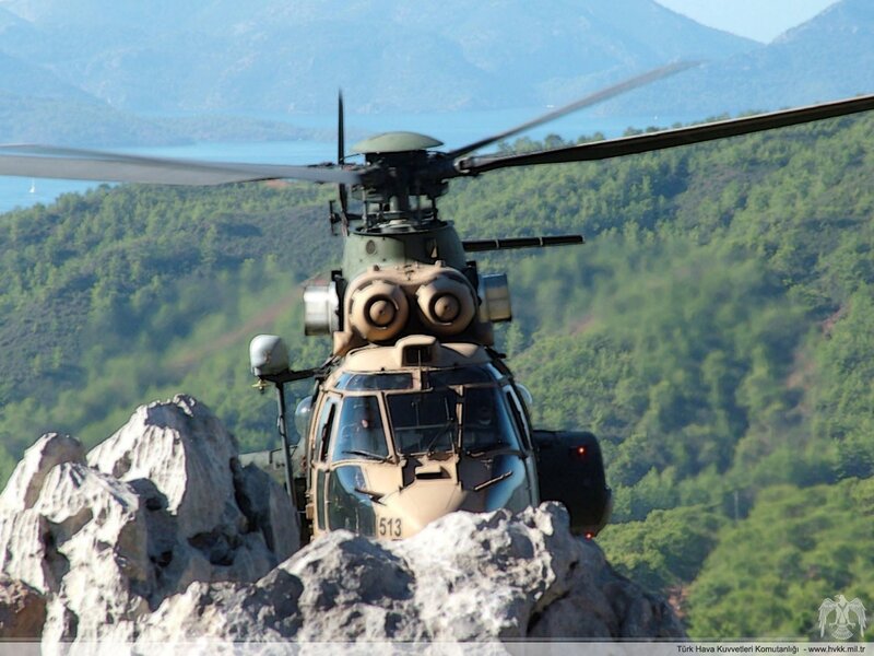 Military helicopter in mountainous terrain