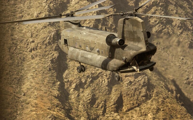 Military helicopter in mountainous terrain