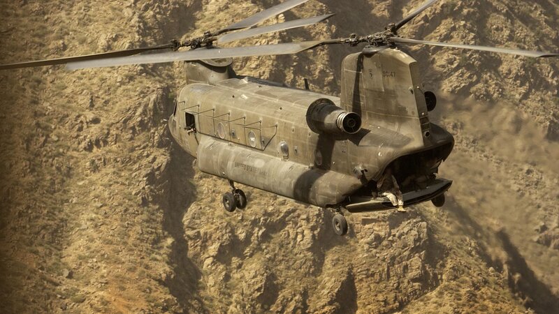 Military helicopter in mountainous terrain