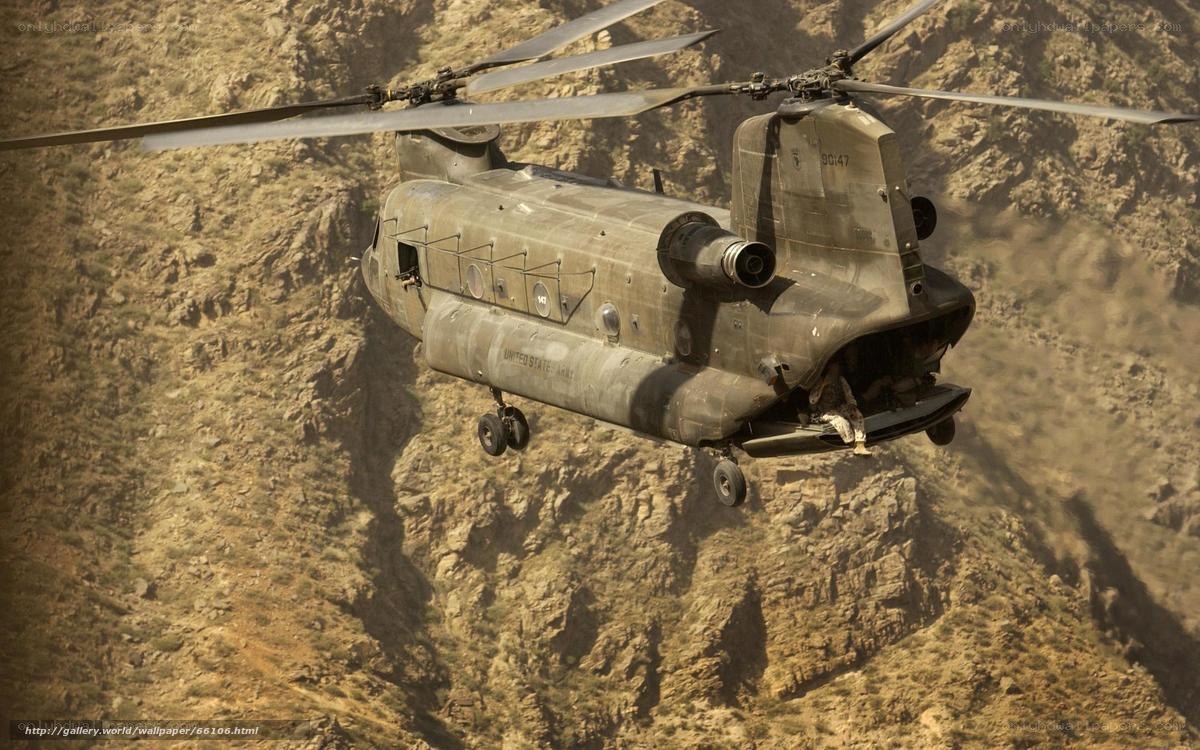 Military helicopter in mountainous terrain
