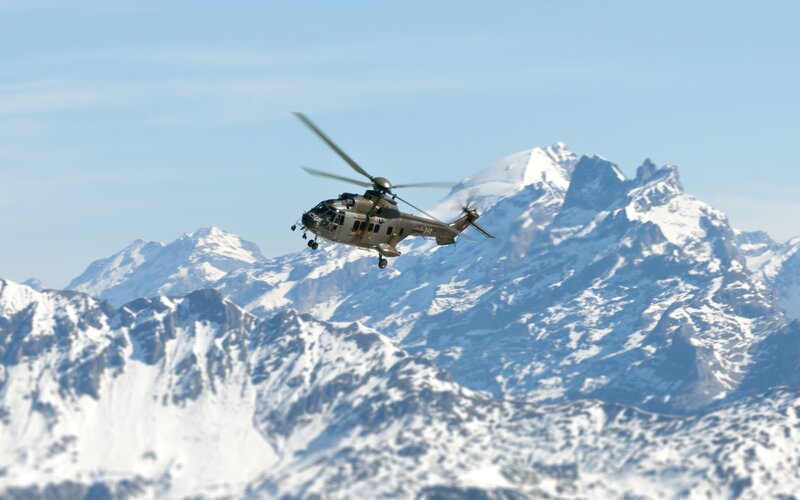 Military Helicopter in Mountains