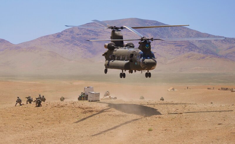 Military helicopter landing in desert