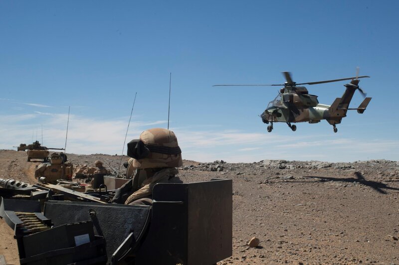 Military helicopter landing in desert