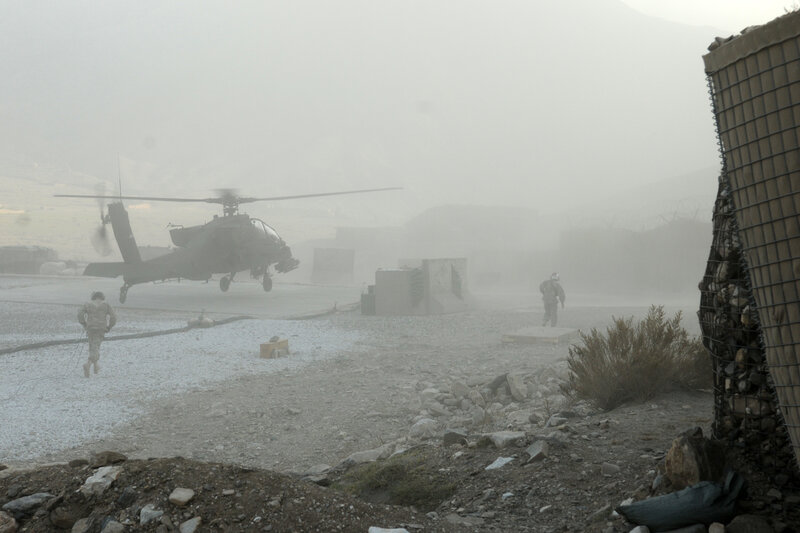 Military helicopter landing in dust