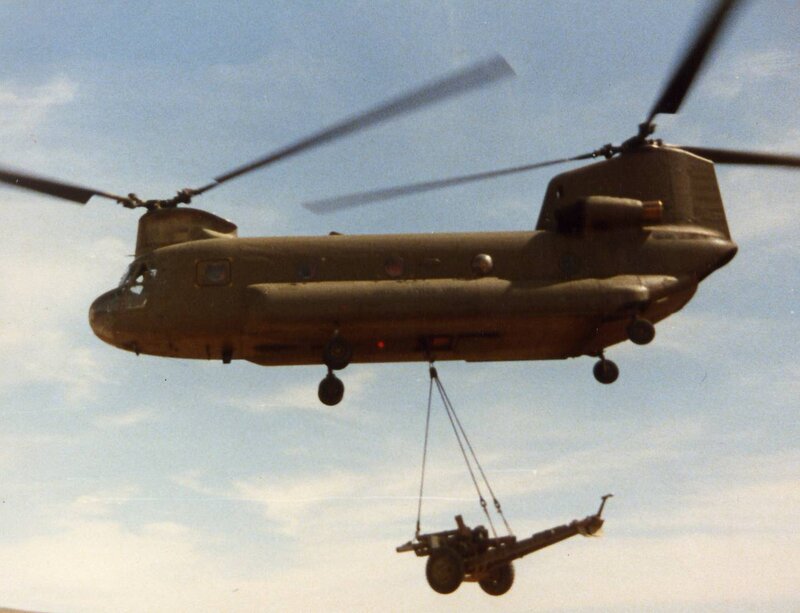 Military helicopter lifting artillery