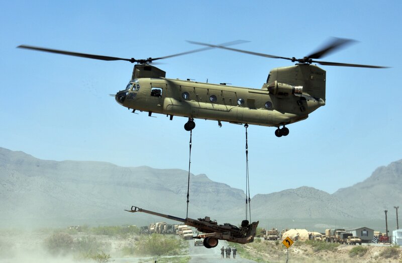 Military Helicopter Lifting Artillery — Green