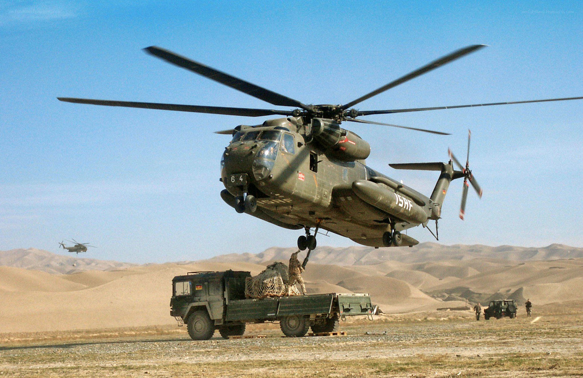 Military helicopter lifting cargo