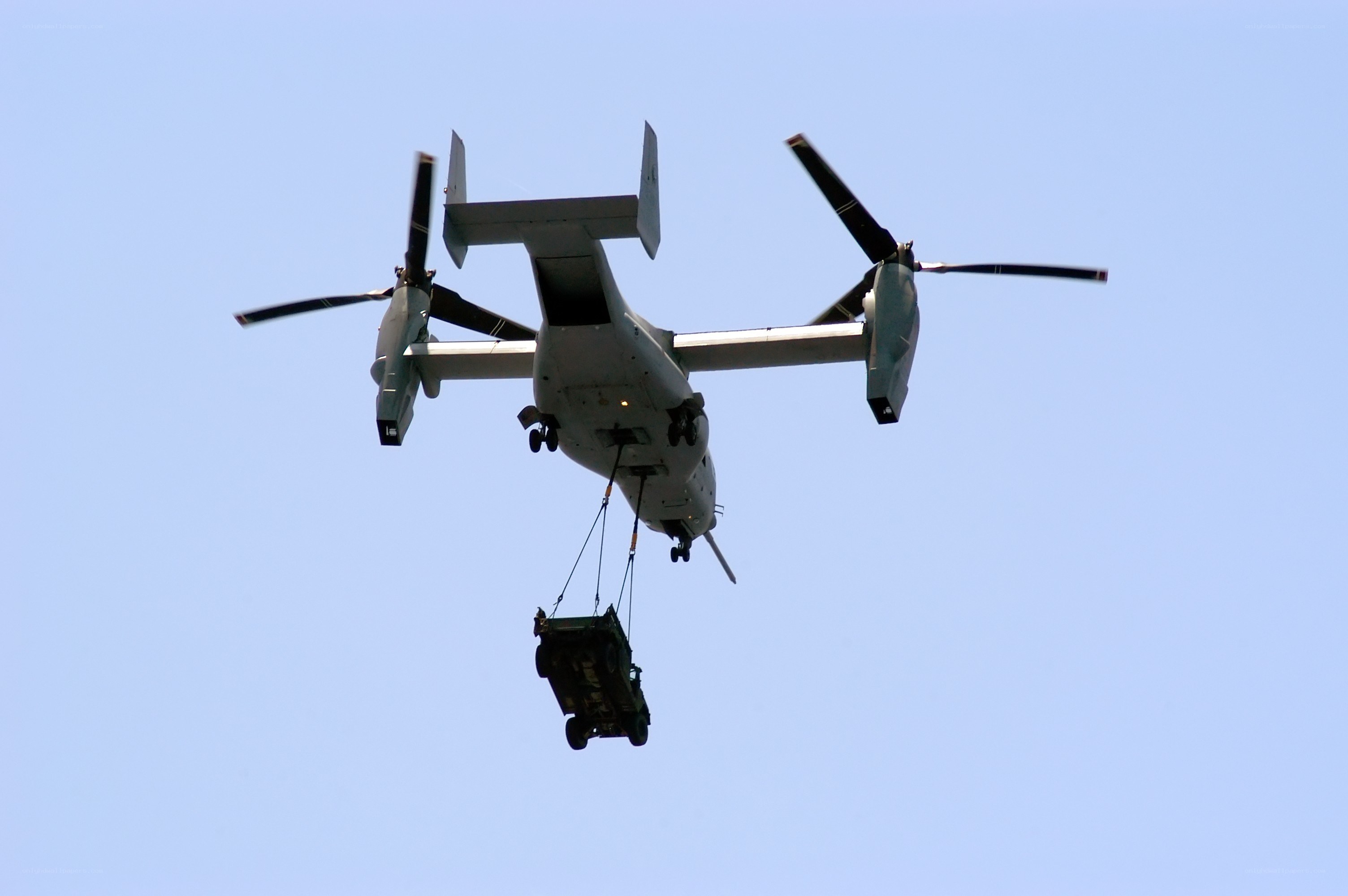 Military helicopter lifting cargo