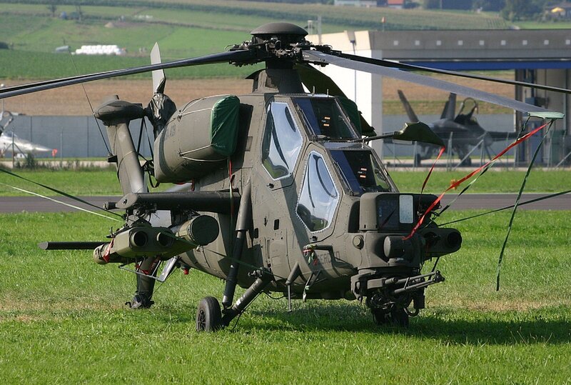 Military helicopter on grass field