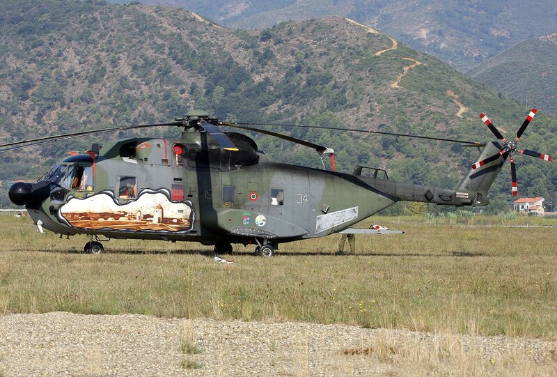 Military helicopter on grass field