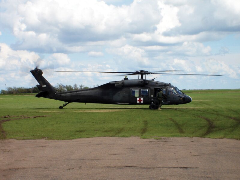 Military helicopter on grass field