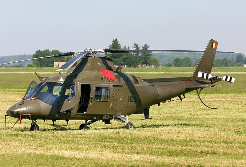 Military helicopter on grass field