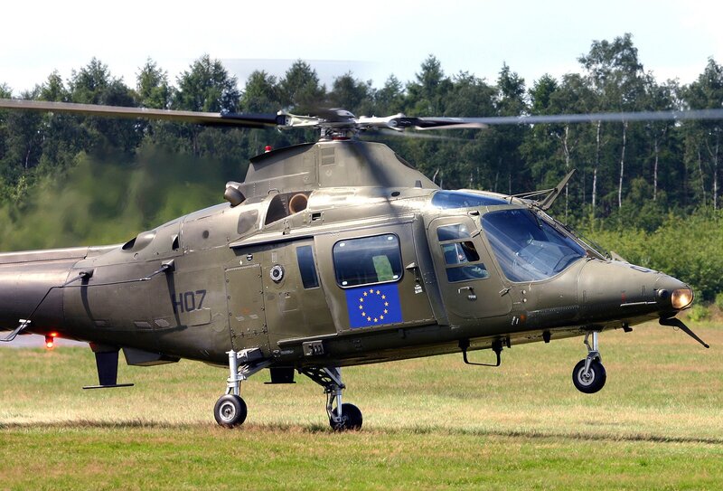 military helicopter on grass field