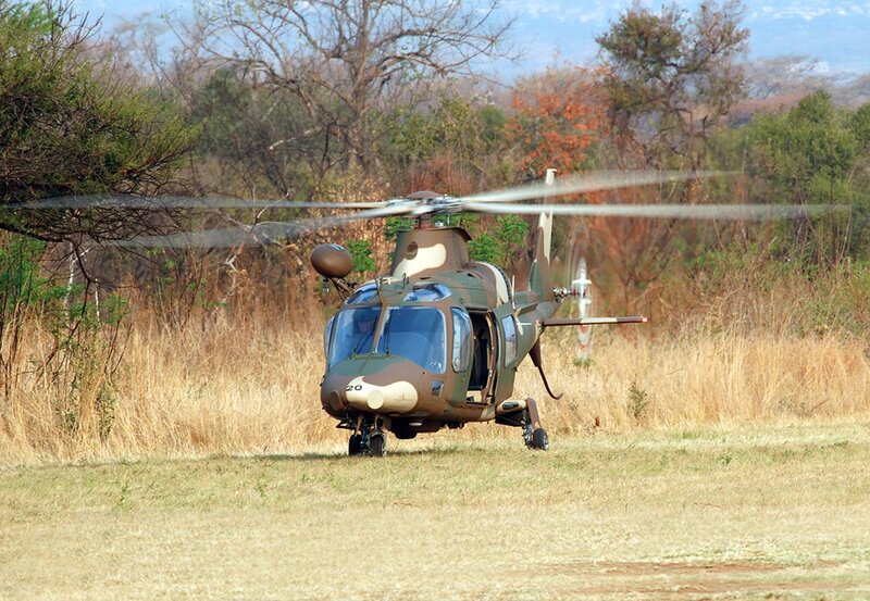 Military helicopter on grass field