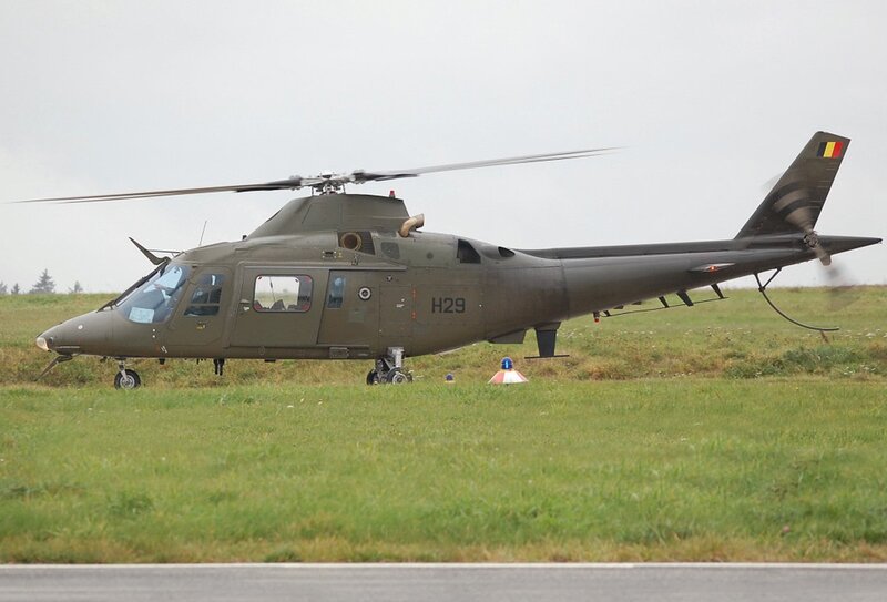 Military helicopter on grass field