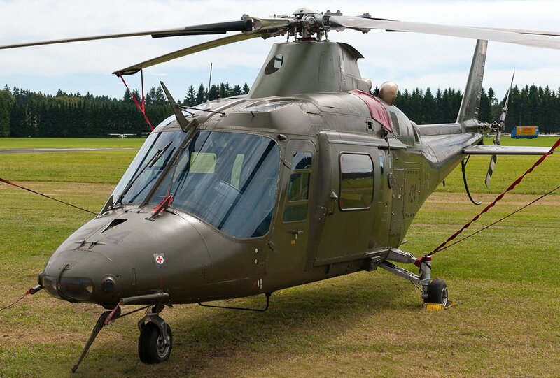 Military helicopter on grass field