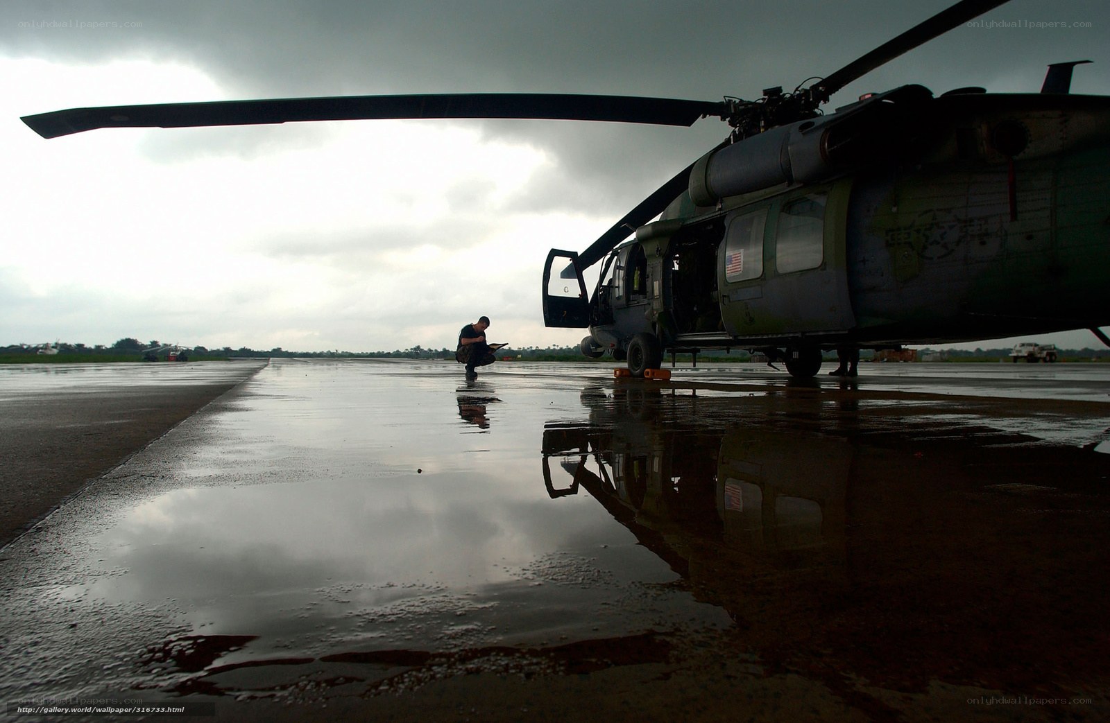 Military helicopter on wet tarmac