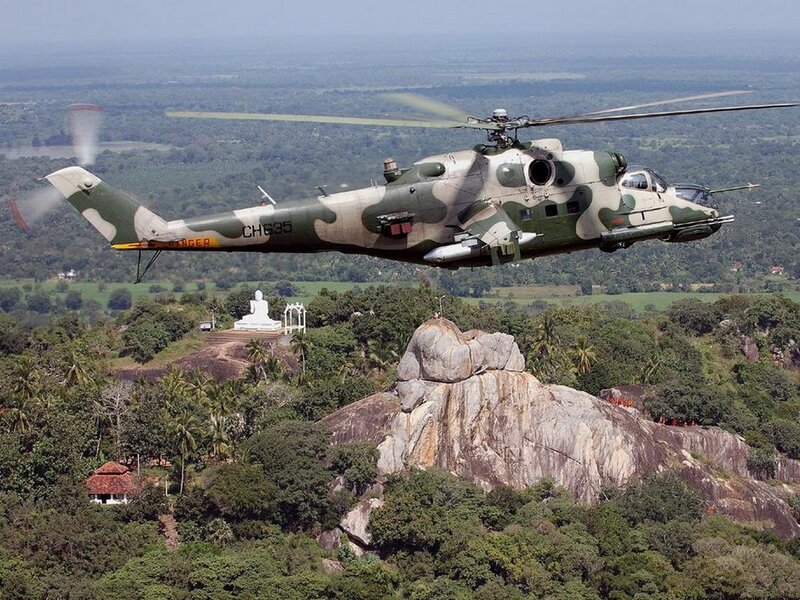 Military helicopter over a rocky landscape