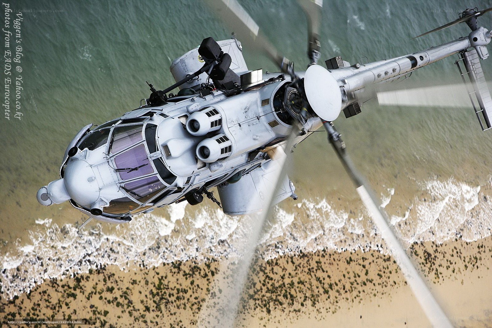 military helicopter over beach