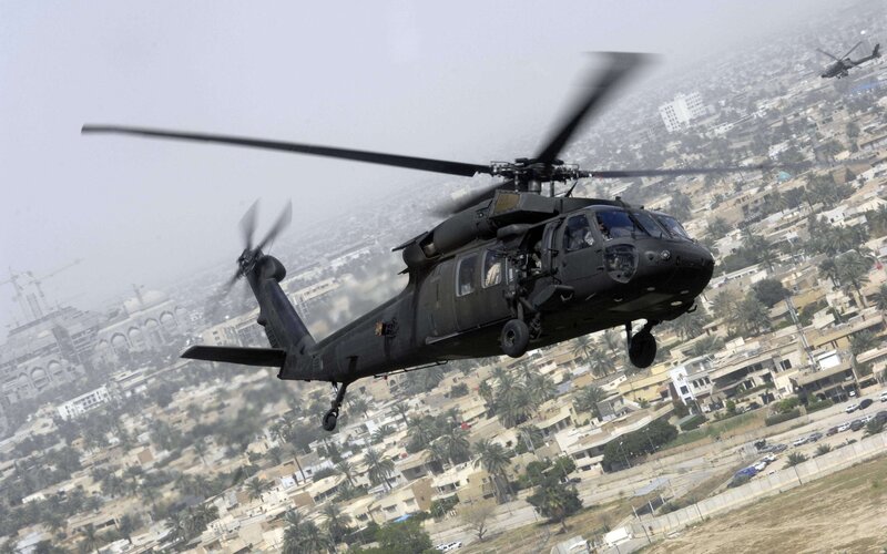 Military helicopter over city