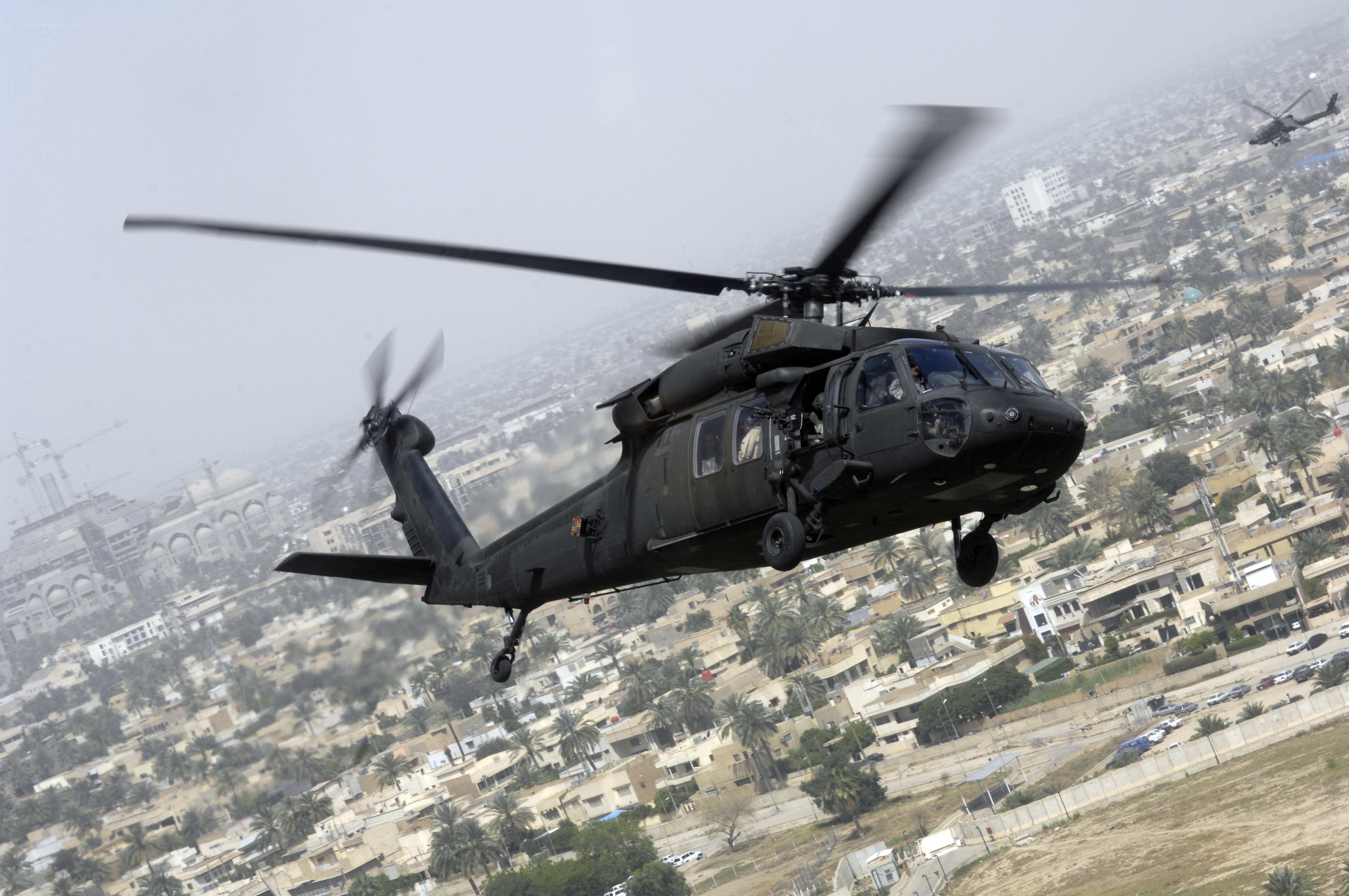 Military helicopter over city