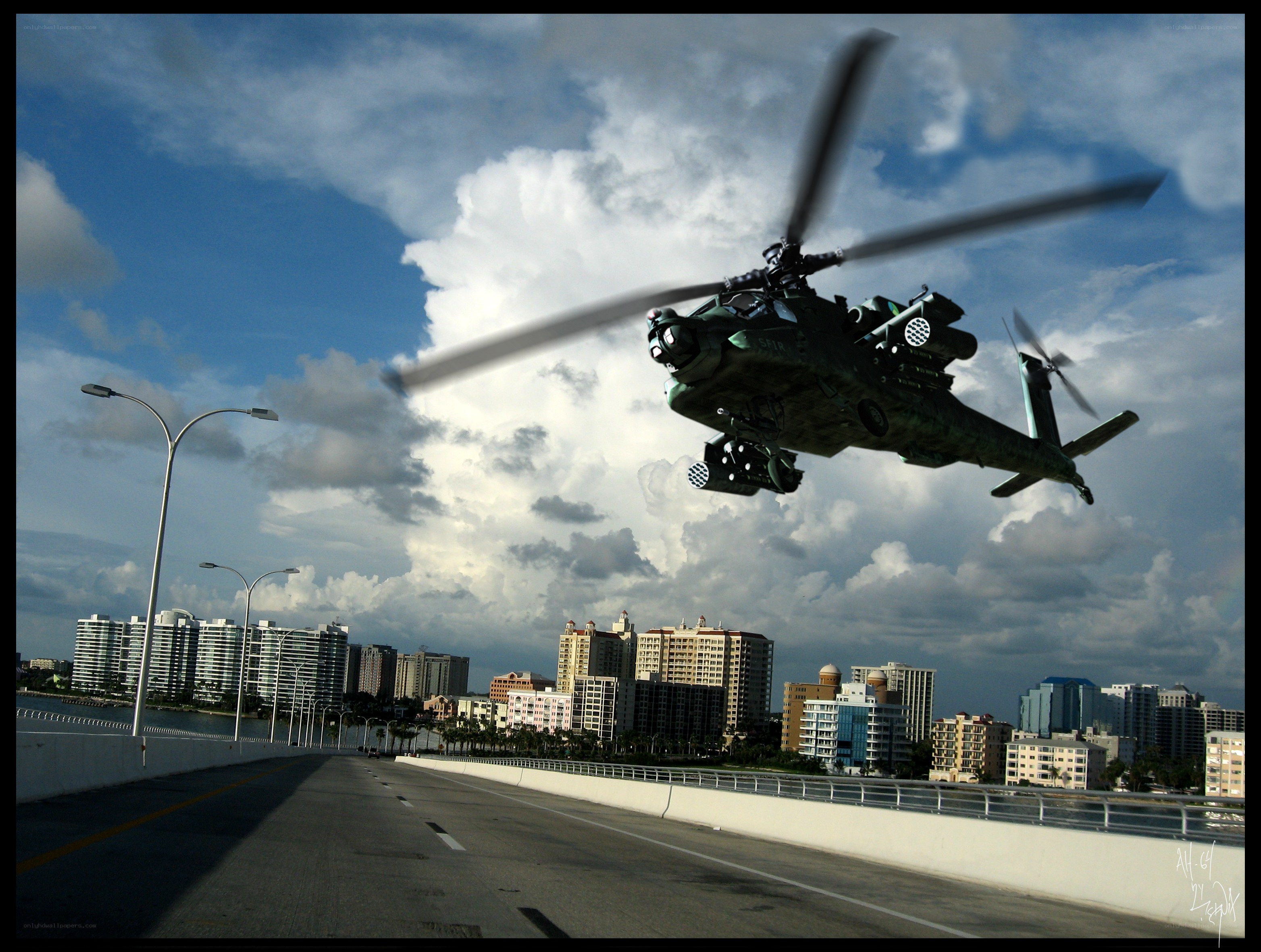 Military helicopter over city bridge