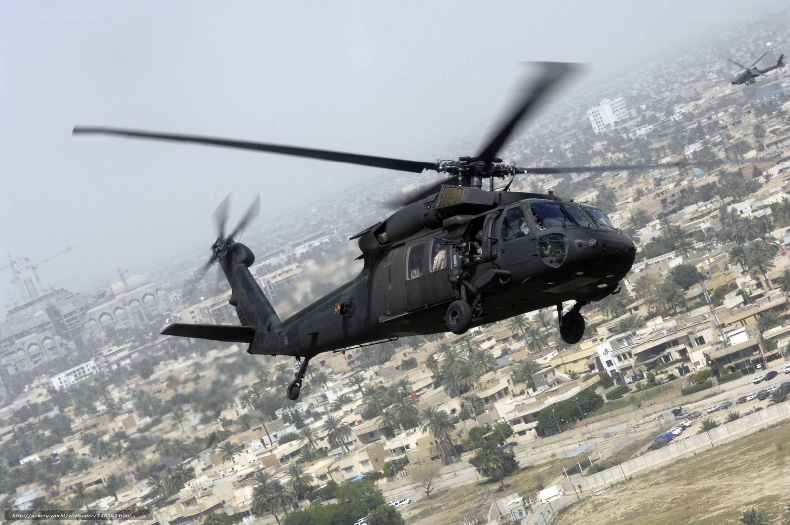 Military helicopter over city