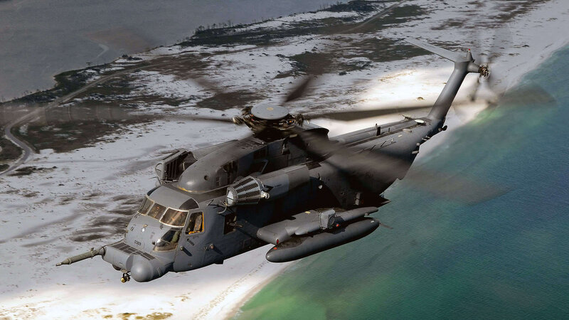 military helicopter over coastline