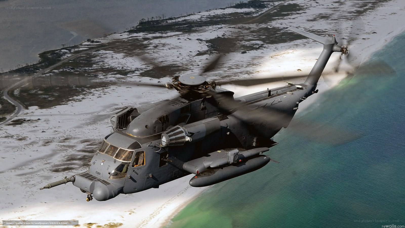 Military helicopter over coastline