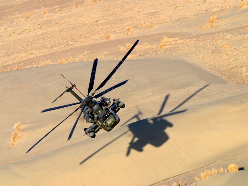 Military helicopter over desert