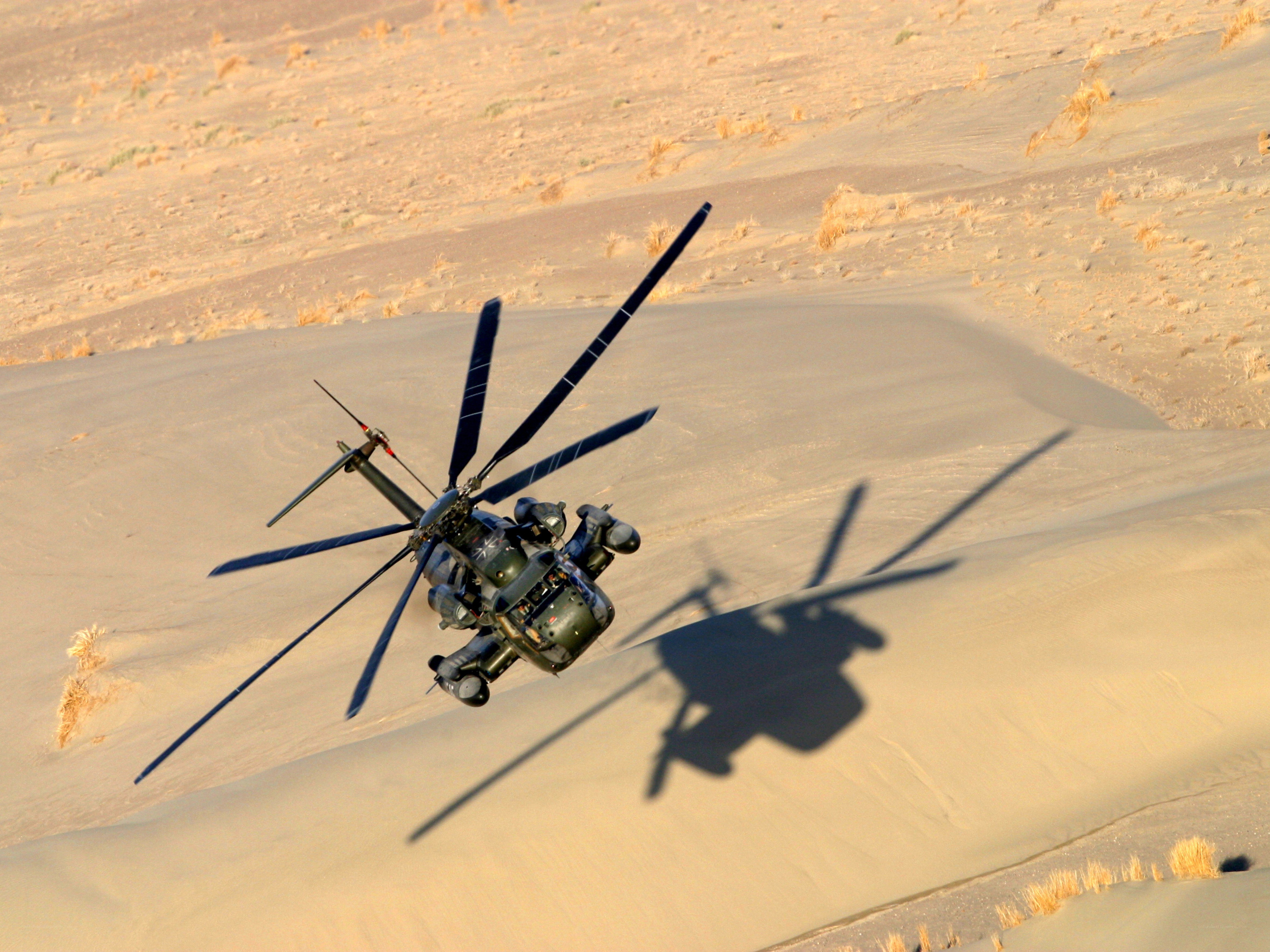 Military helicopter over desert