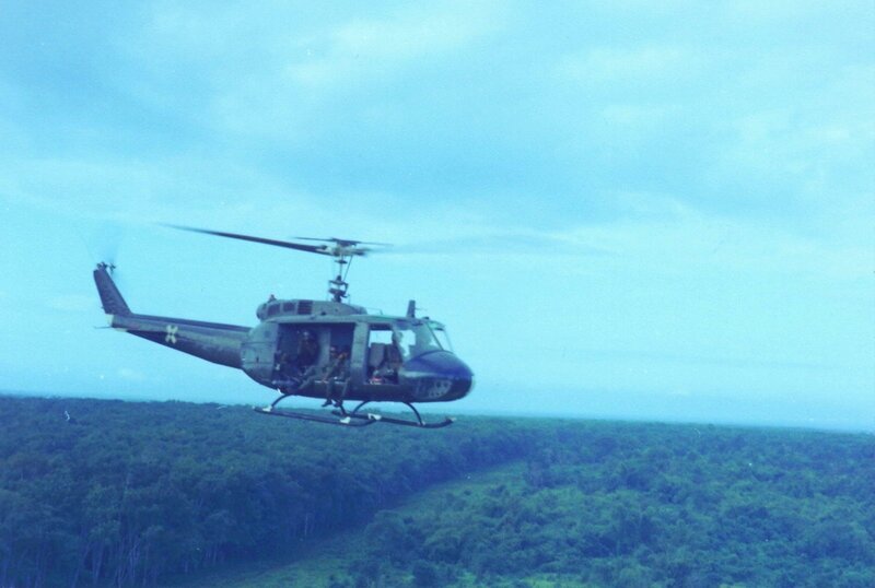 Military helicopter over forest