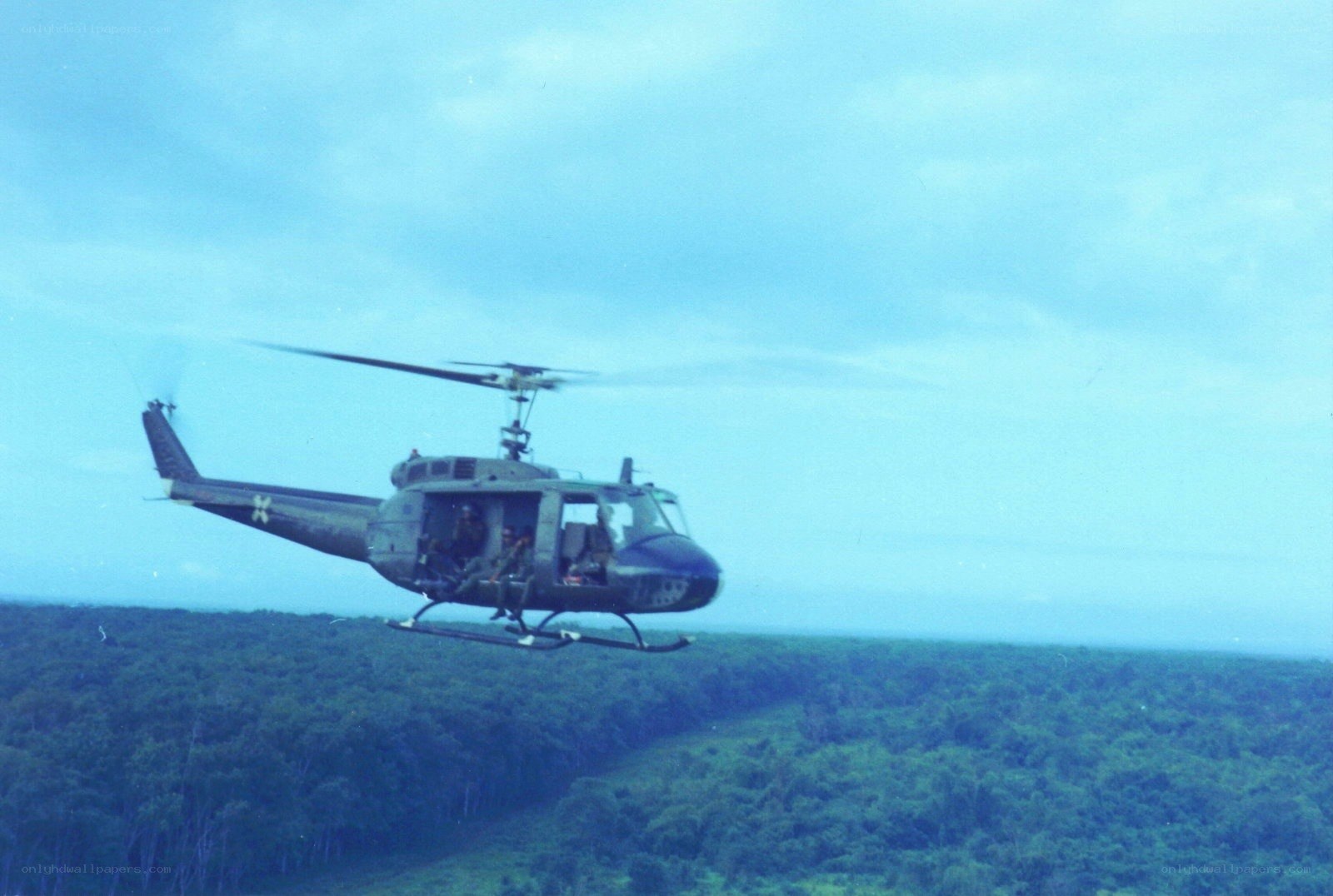 Military helicopter over forest