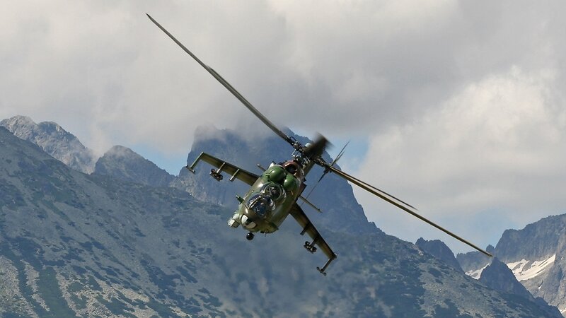 Military helicopter over mountains