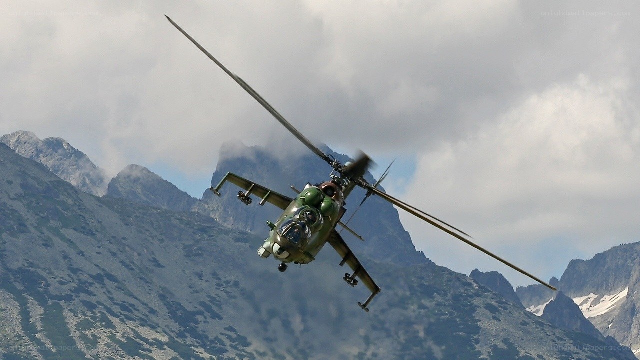 Military helicopter over mountains