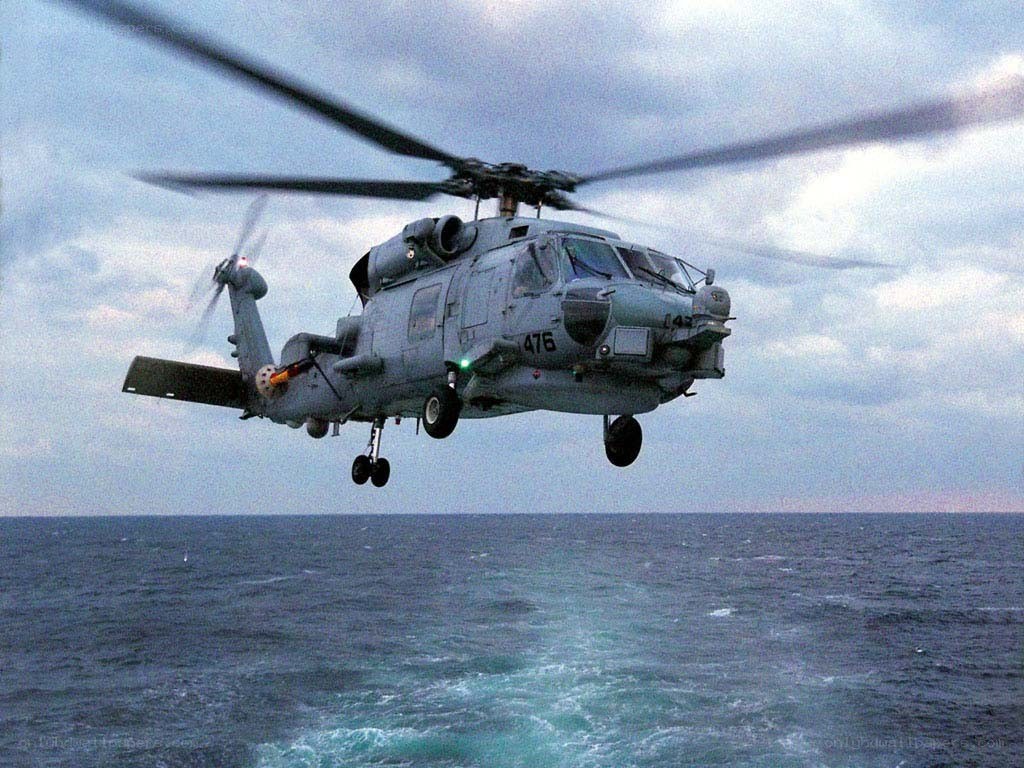 Military helicopter over ocean