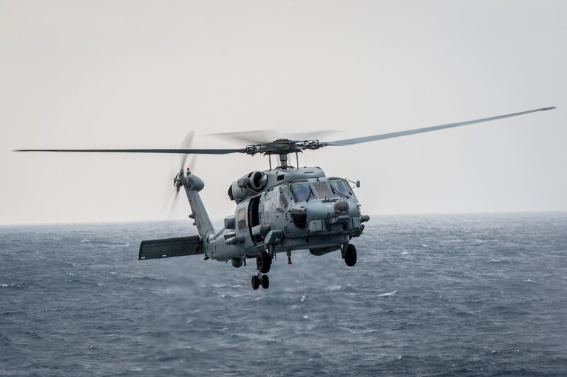 Military Helicopter over Ocean — Gray, Overcast