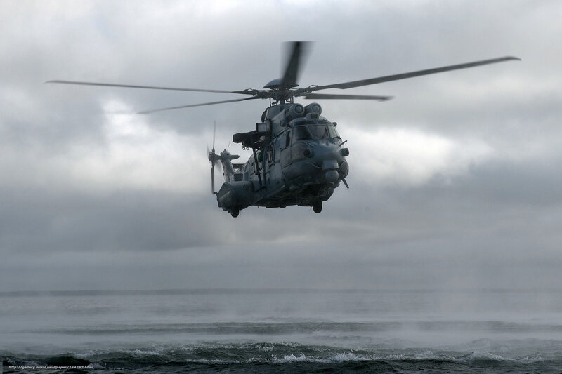 Military helicopter over ocean