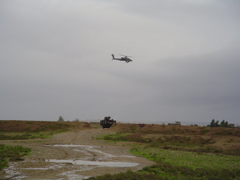 Military helicopter over terrain