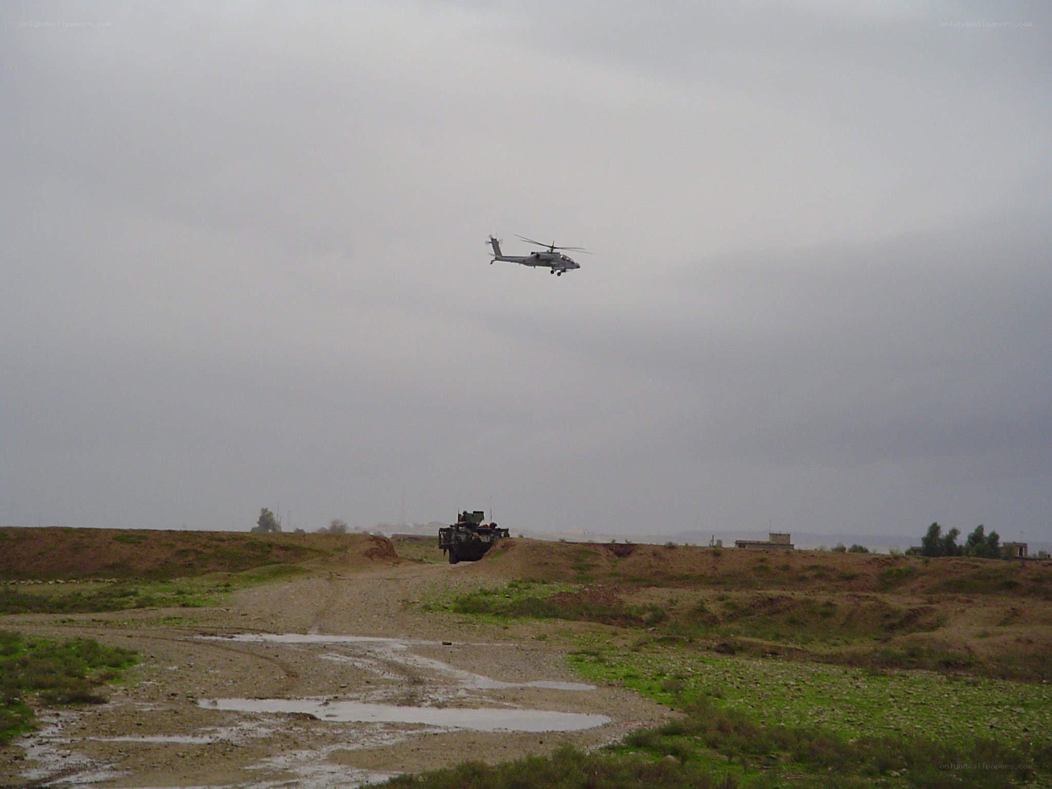Military helicopter over terrain