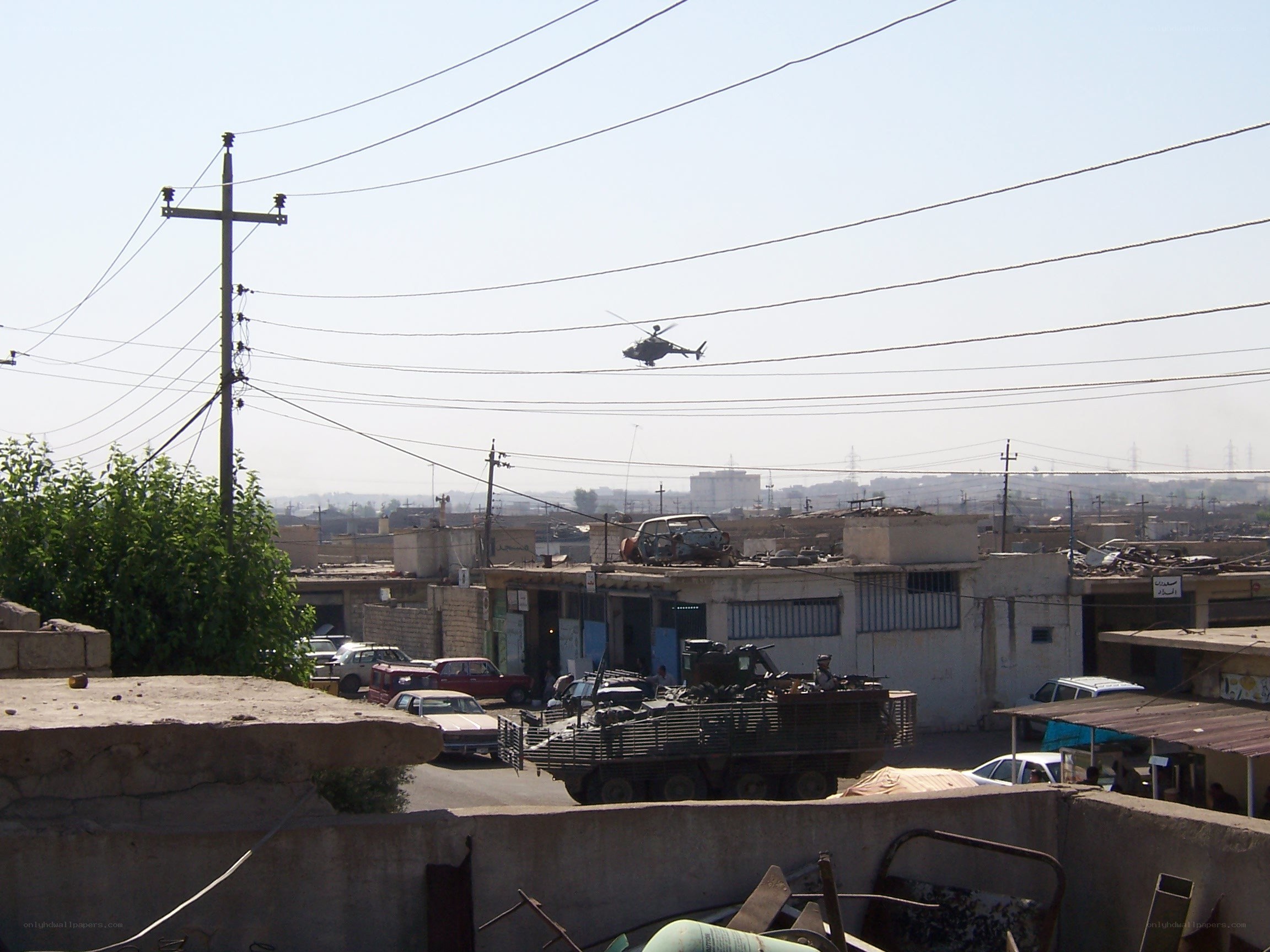 Military helicopter over urban area