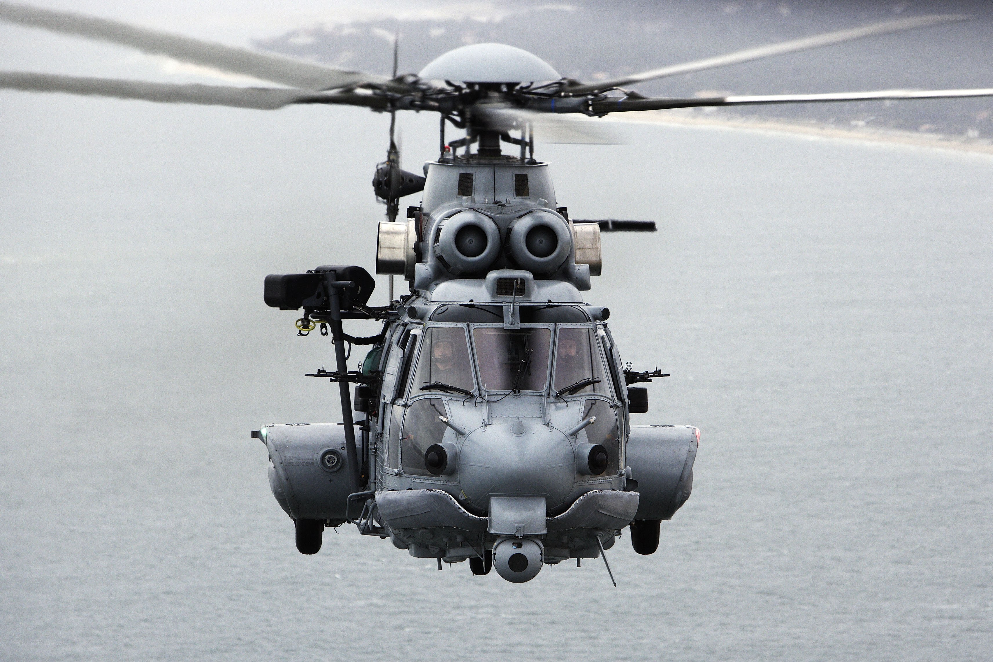 Military helicopter over water