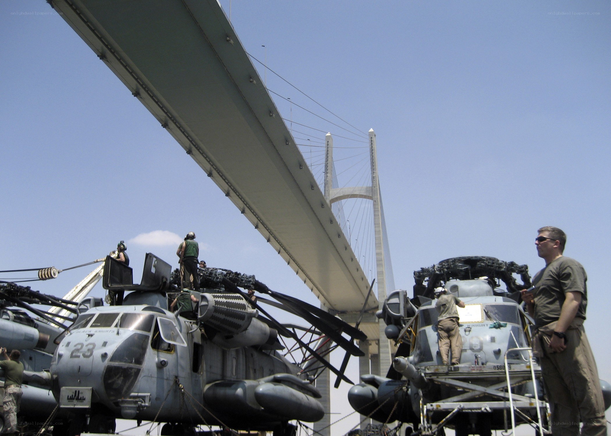 Military helicopters on a bridge