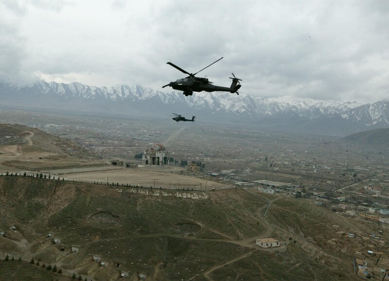 Military helicopters over a city