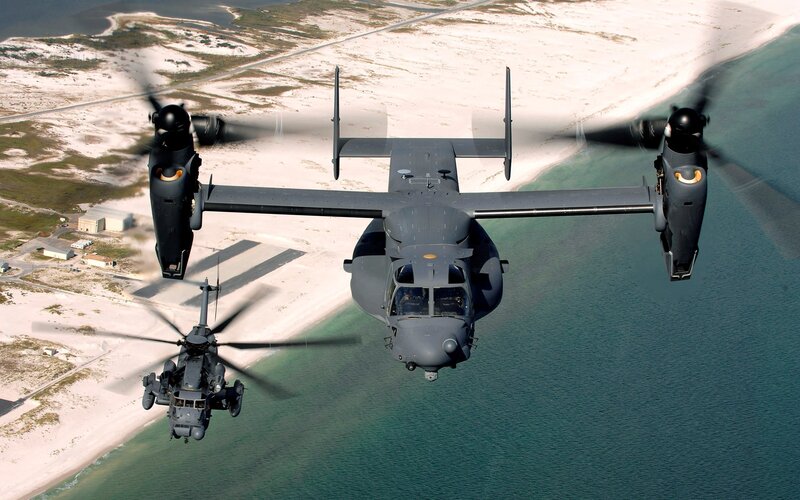 Military helicopters over coastline