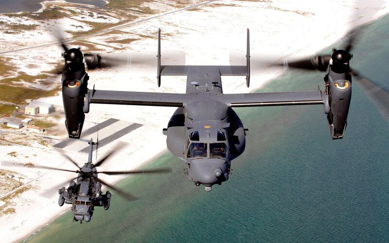 Military helicopters over coastline