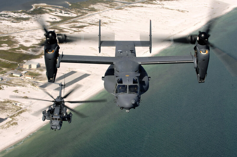 Military helicopters over coastline